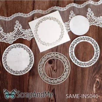 White lace doilies and decorative frames on wooden background